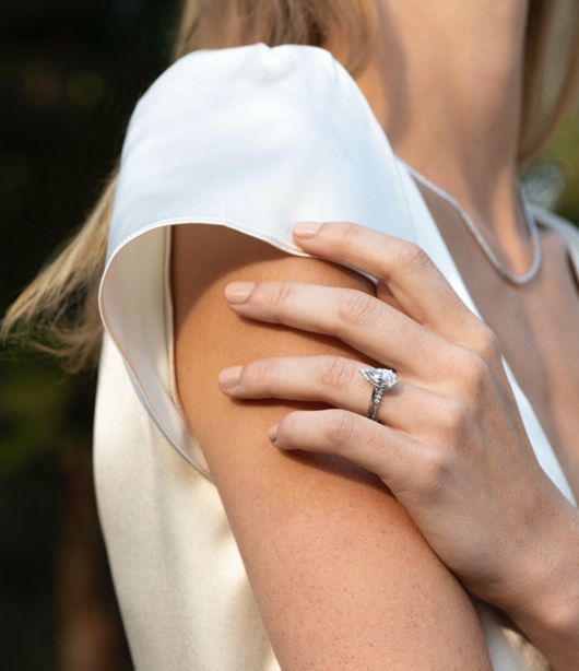 A woman wearing an engagement ring